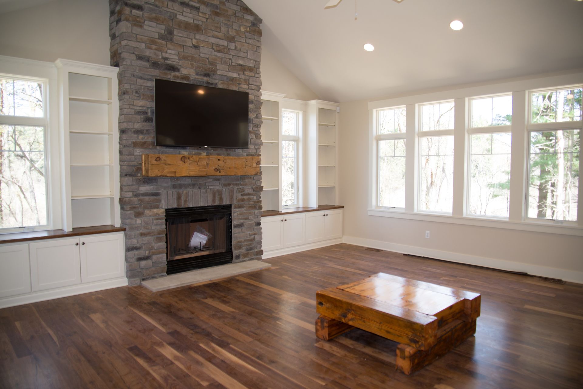 A living room with a fireplace and a flat screen tv.