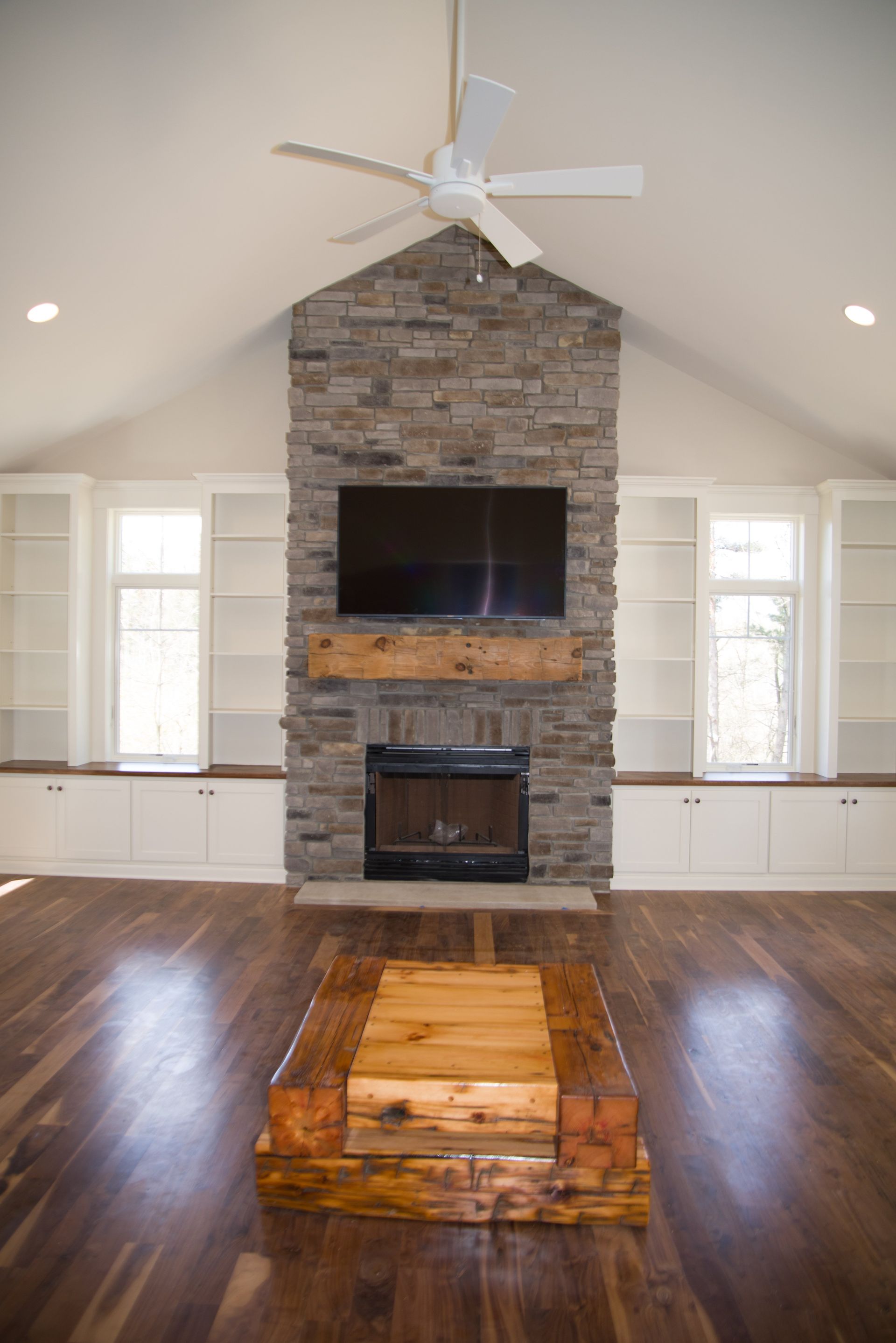 A living room with a fireplace and a flat screen tv.