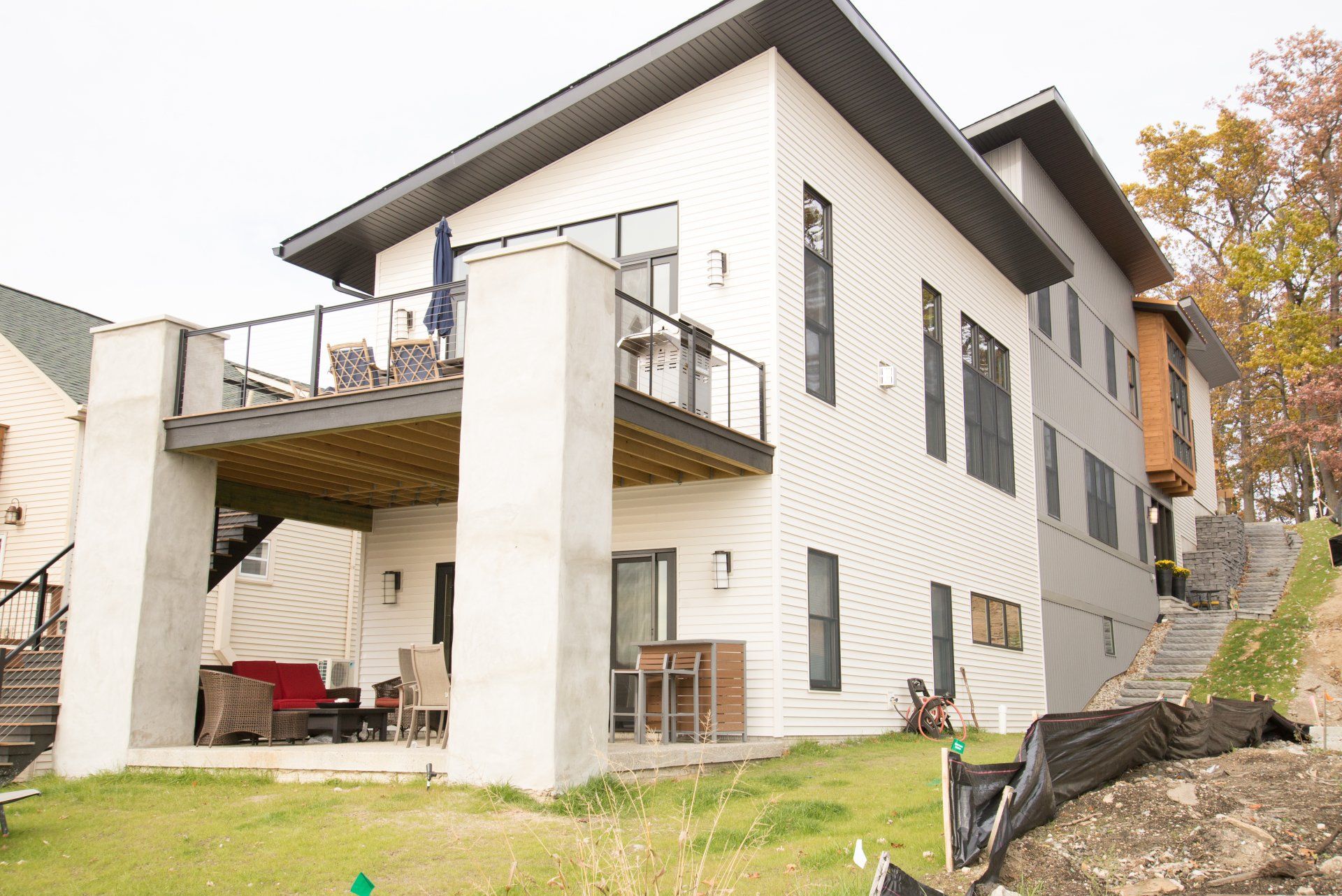A large white house with a balcony and stairs