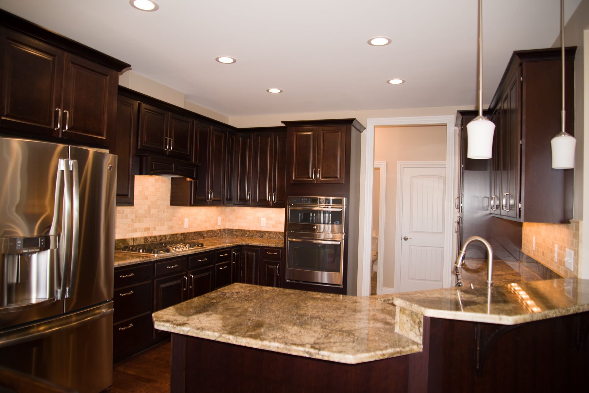 A kitchen with stainless steel appliances and granite counter tops