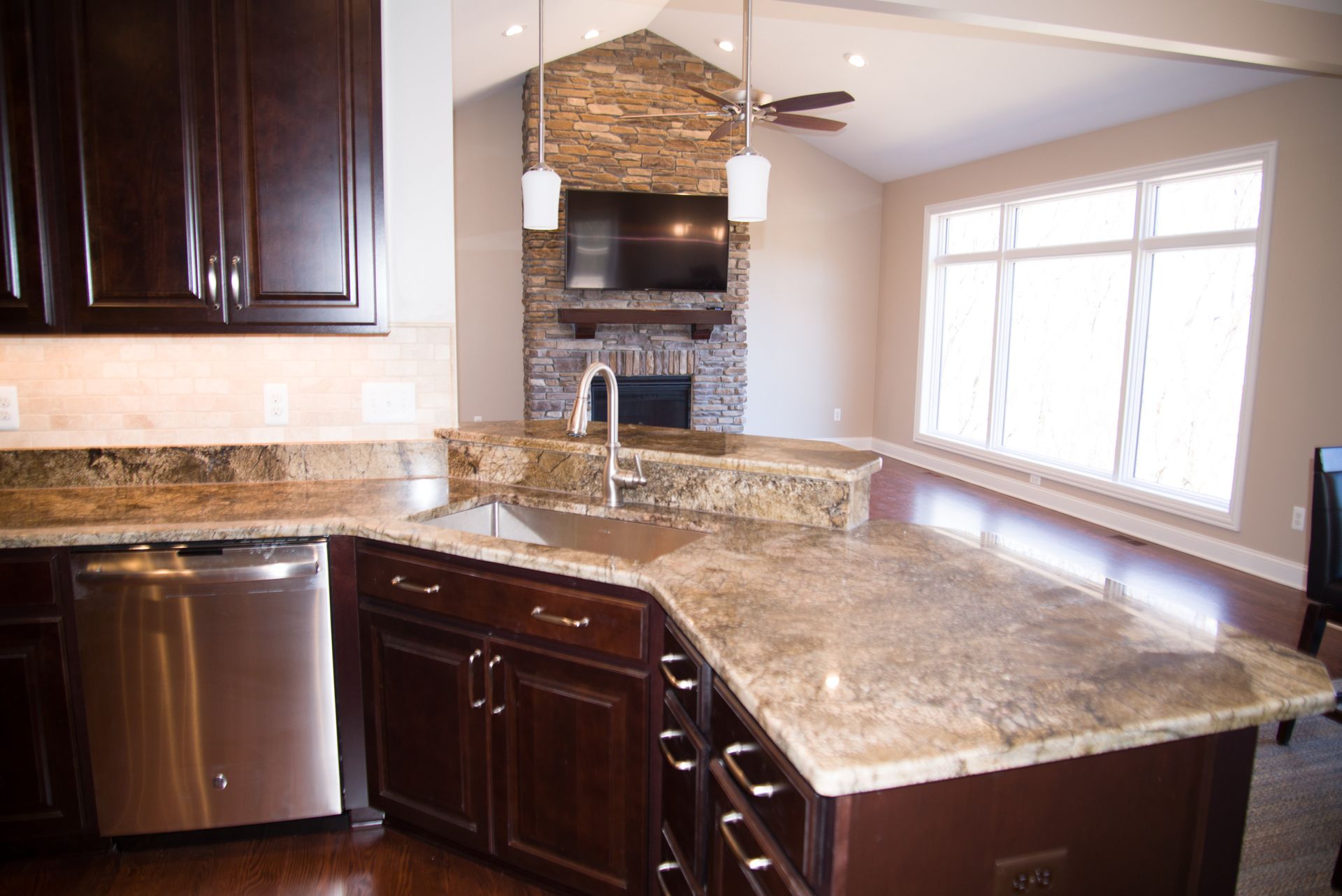 A kitchen with granite counter tops and stainless steel appliances.