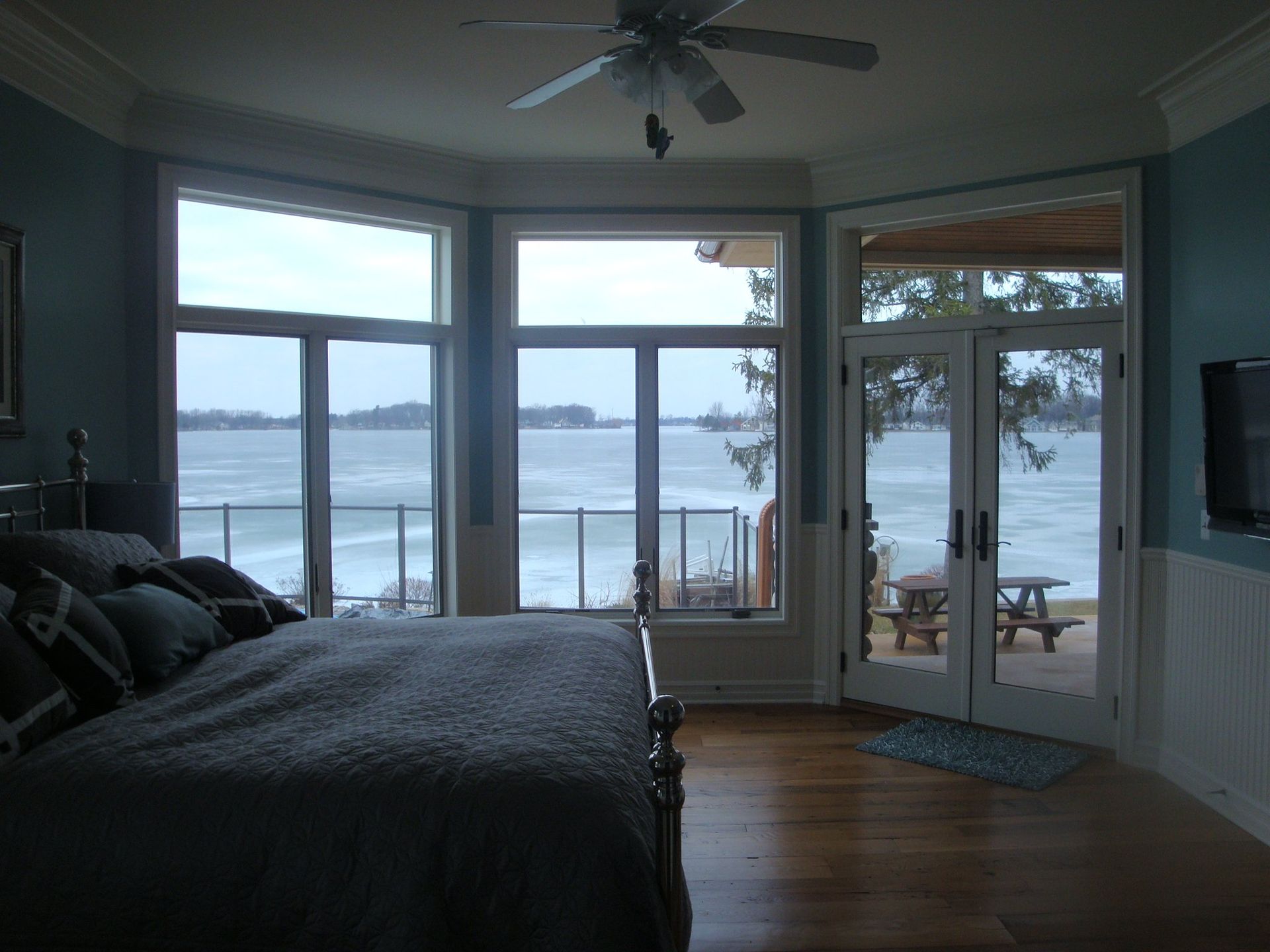 A bedroom with a large bed and a view of the ocean