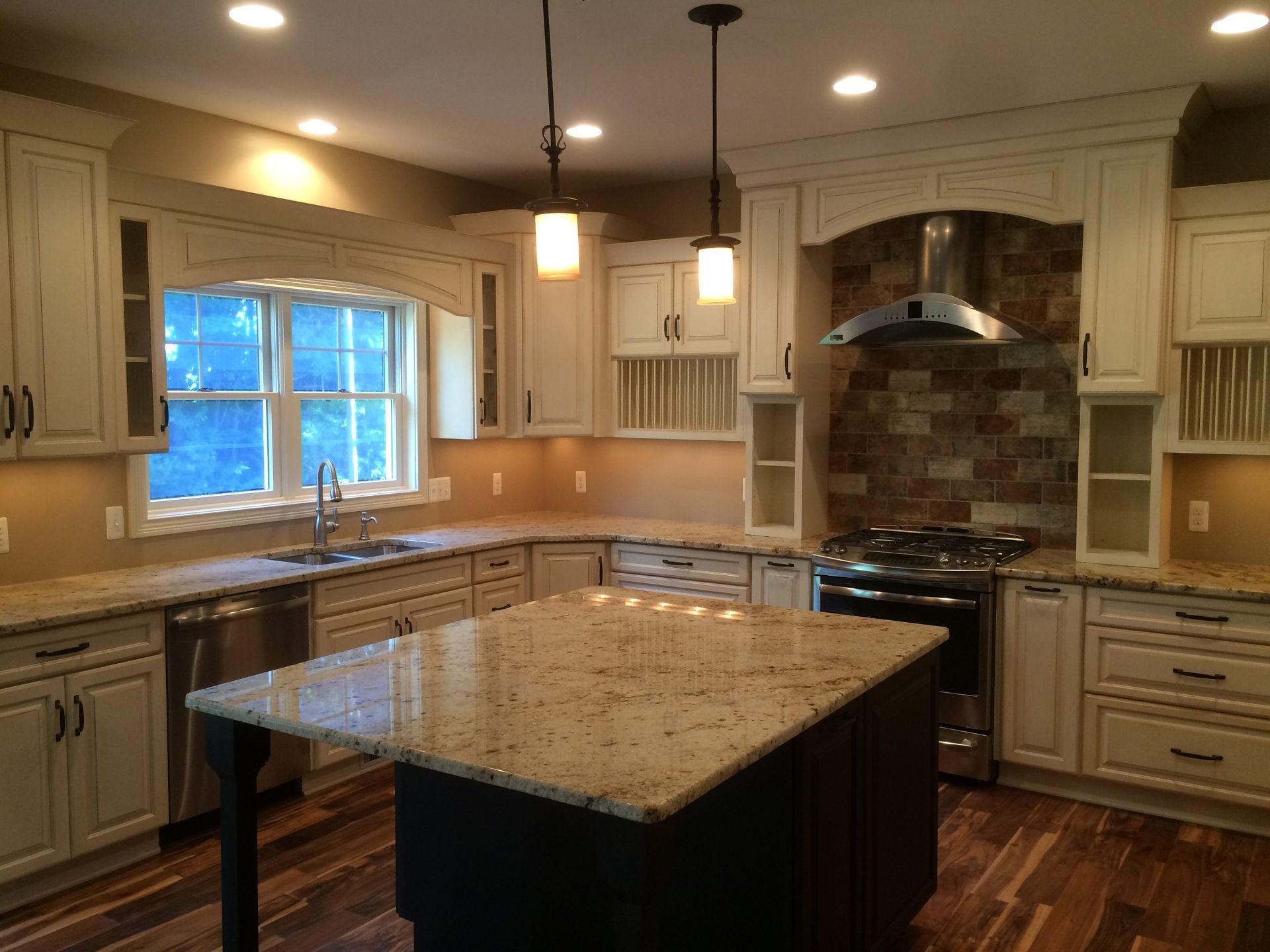 A kitchen with white cabinets and granite counter tops