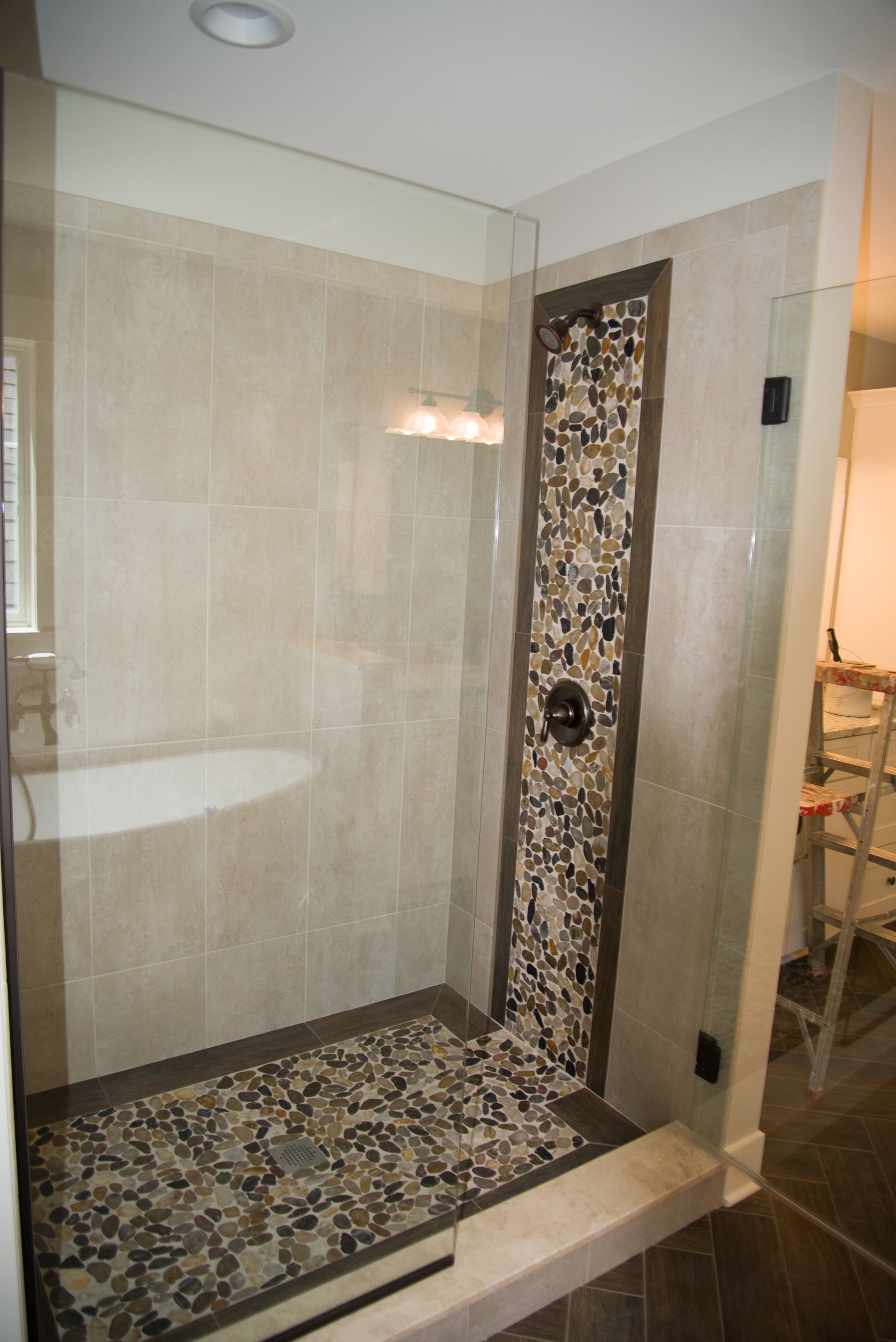A bathroom with a walk in shower and a bathtub.