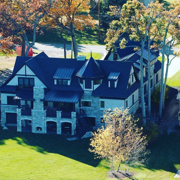 An aerial view of a large house surrounded by trees