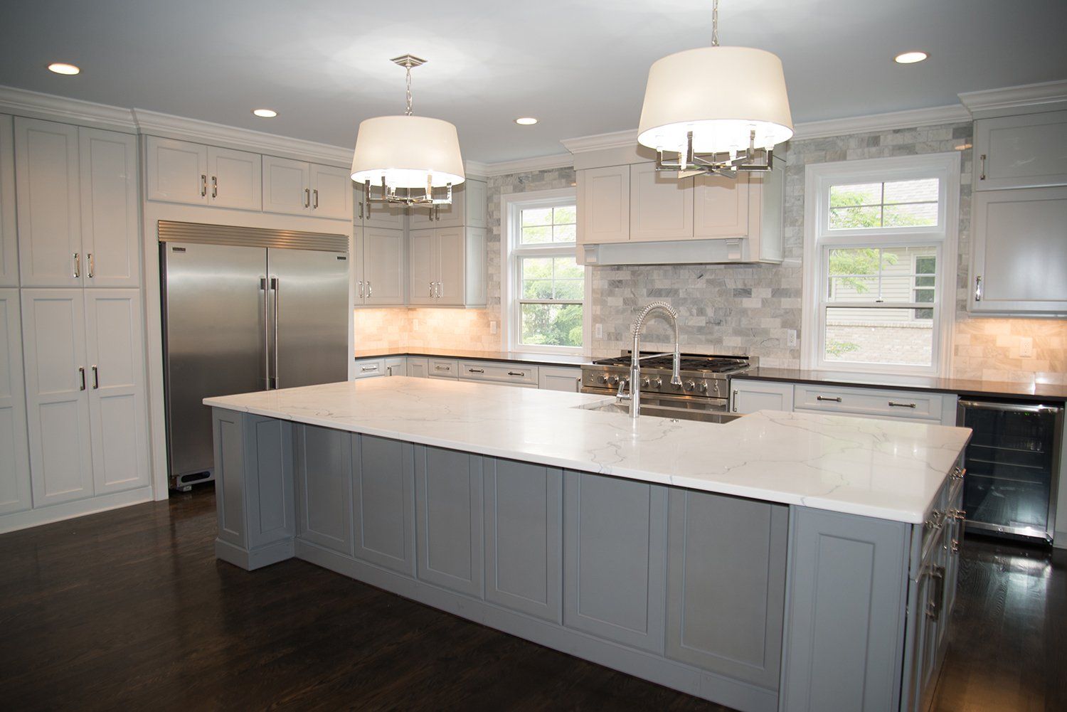 A kitchen with a large island and stainless steel appliances.