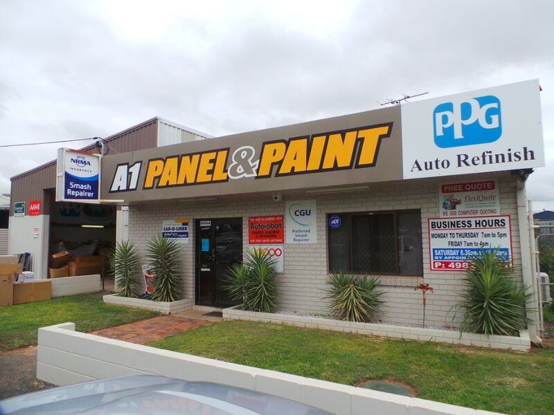 A1 Panel & Paint Storefront With Ppg Auto Refinish Signage on a Cloudy Day — A1 Panel & Paint In Emerald, QLD