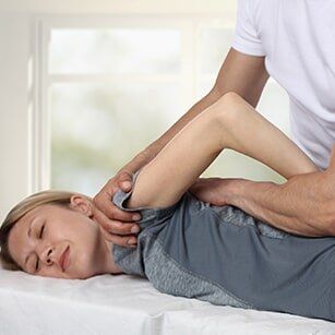 Spine — Woman Having Chiropractic Back Adjustment in Redding, CA Spine — Woman Having Chiropractic Back Adjustment in Redding, CA