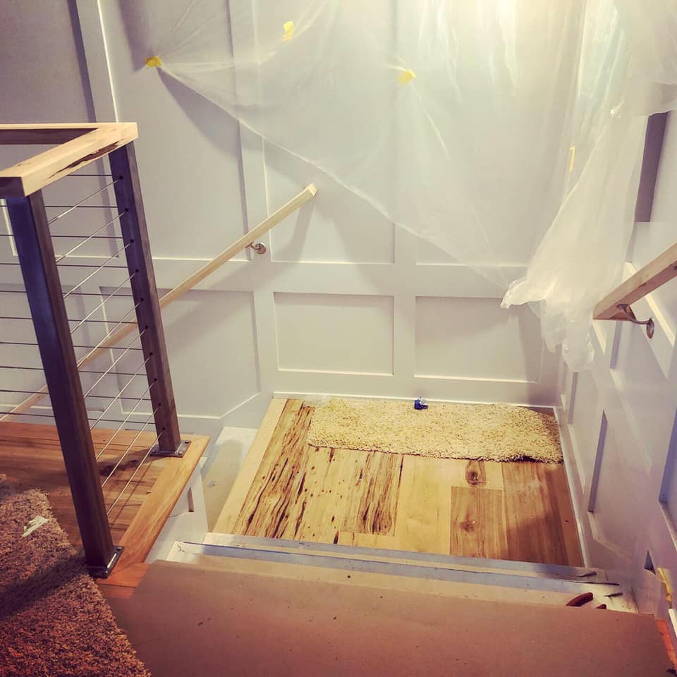 Custom staircase under construction with protective draping, Greenville SC