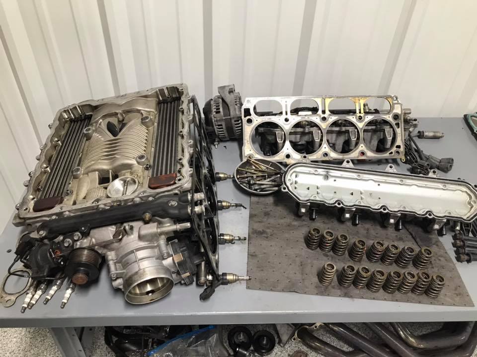 Corvette engine torn apart and disassembled on top of table
