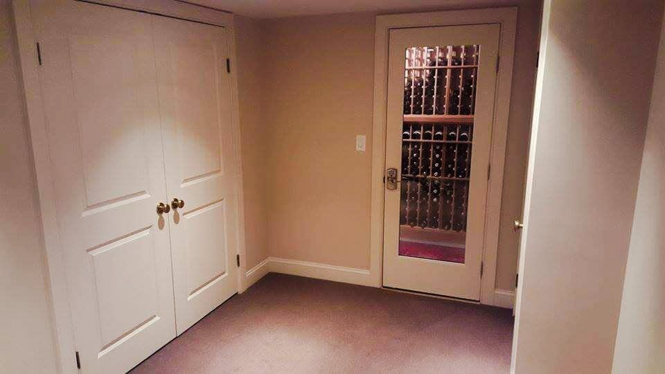 An empty room with a glass door and a closet.