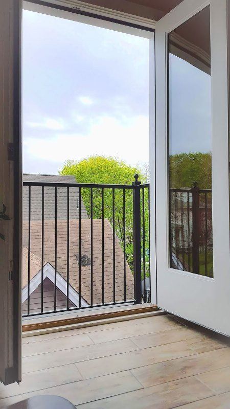 A balcony with a railing and a view of a house.