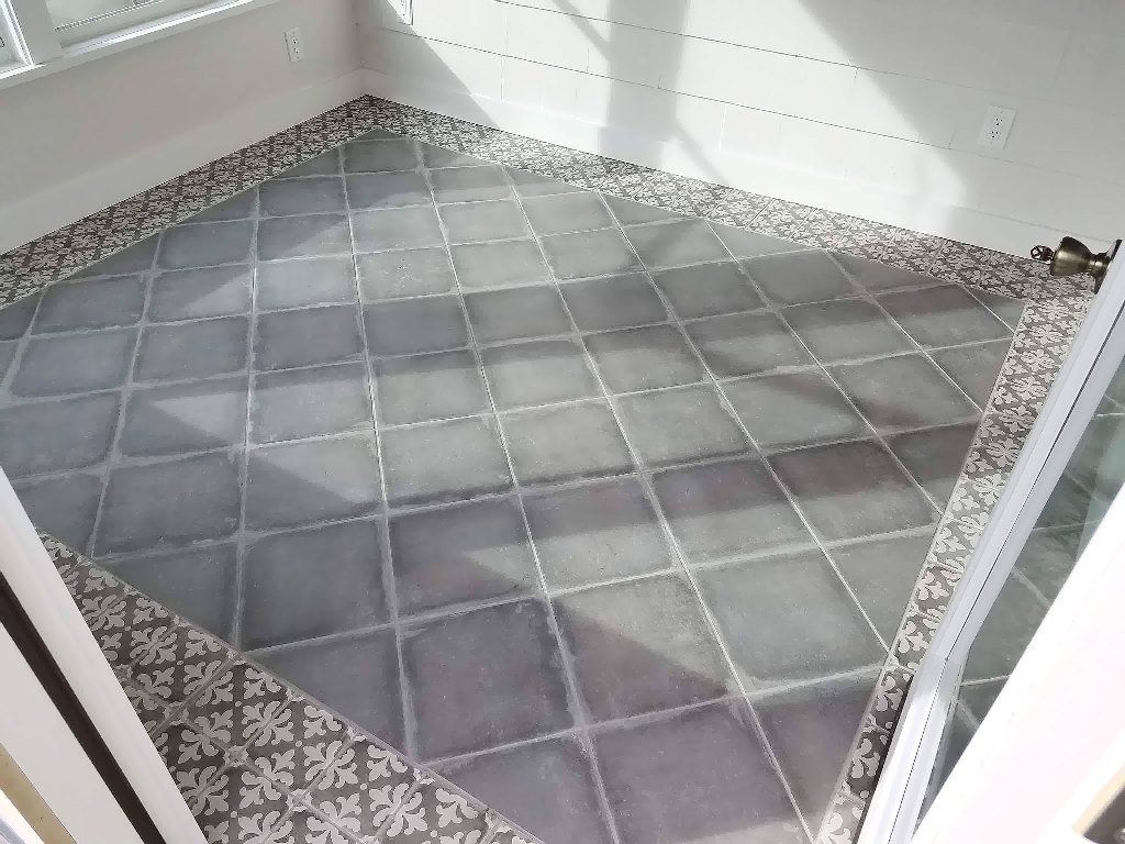 A room with a tiled floor and a sliding glass door
