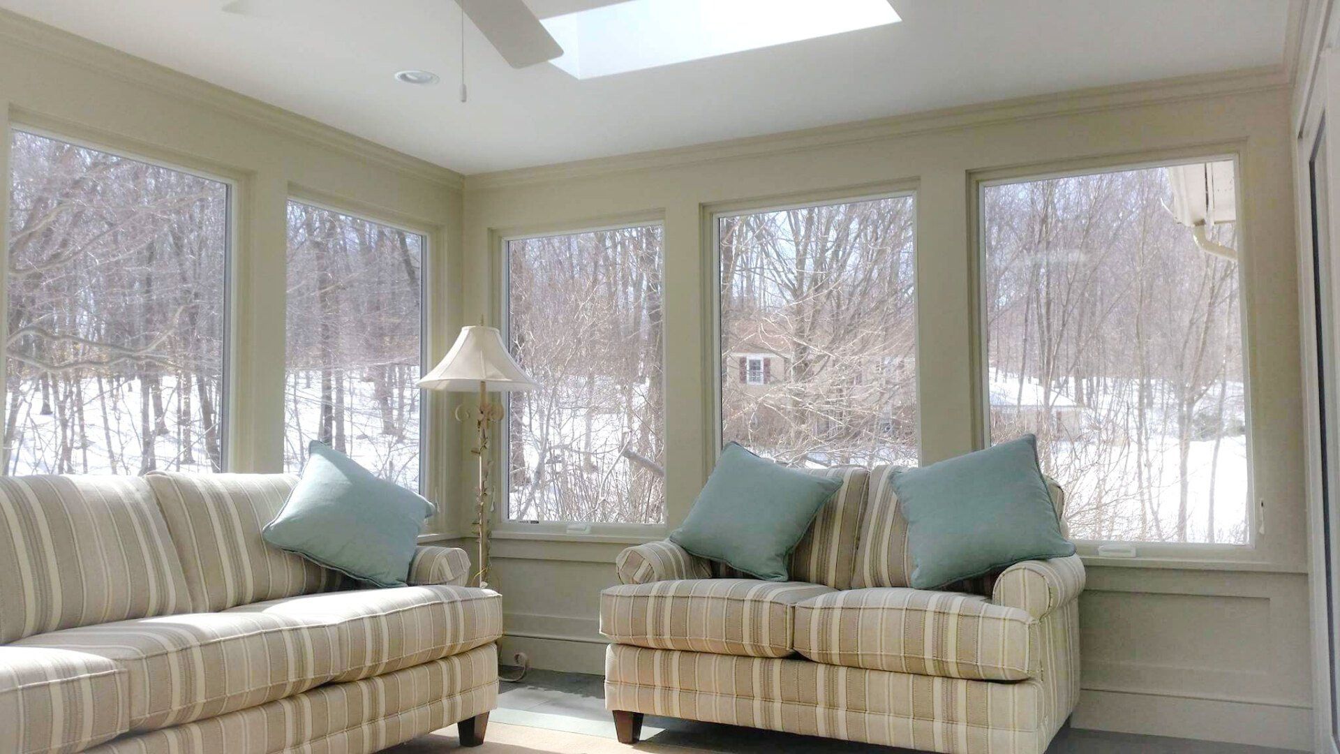 A living room with two couches and a ceiling fan.