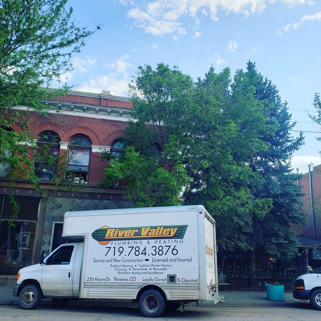 Service Truck Outside The Building — Florence, CO — River Valley Plumbing And Heating LLC Service Truck Outside The Building — Florence, CO — River Valley Plumbing And Heating LLC