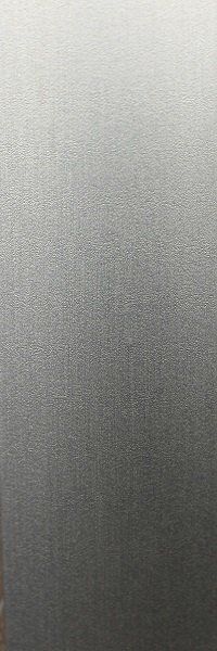 A close up of a stainless steel surface with a brushed finish.