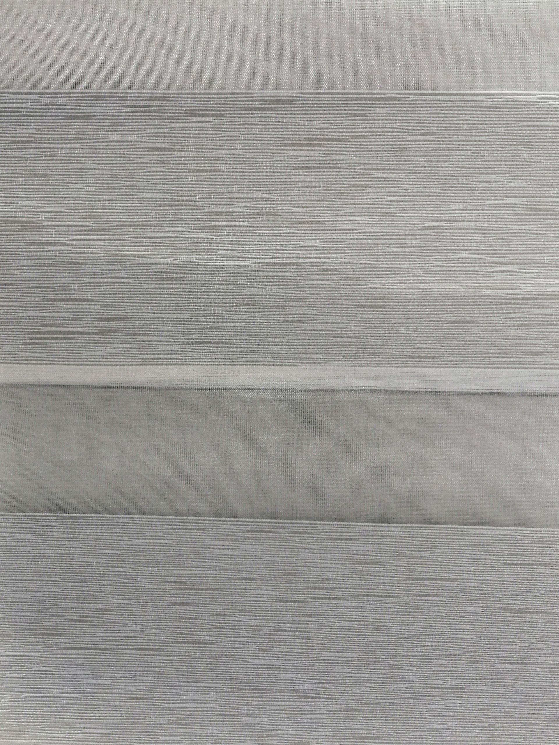 A close up of a piece of wood with a gray grain.