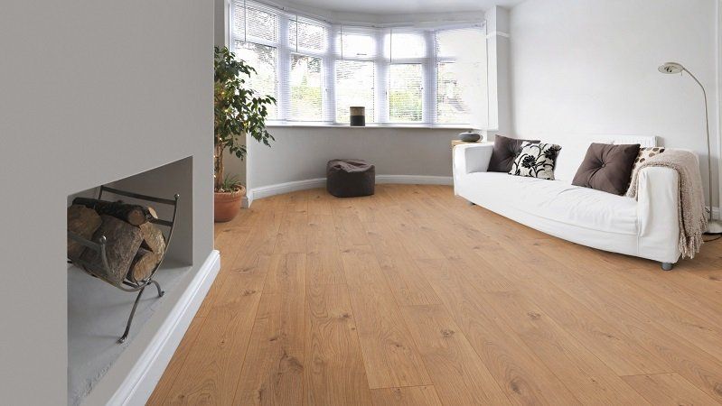 A living room with hardwood floors and a fireplace.