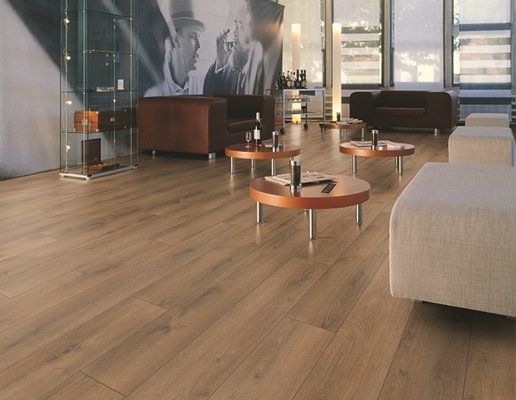 A living room with a wooden floor and tables