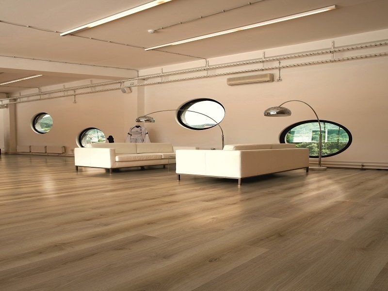 A living room with a couch and two chairs