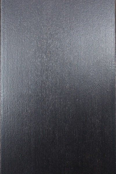 A close up of a black surface with a grainy texture.