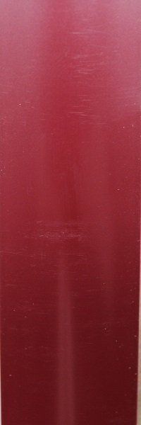 A close up of a glass of red liquid on a table.