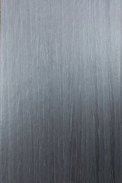 A close up of a piece of metal with a gray texture.