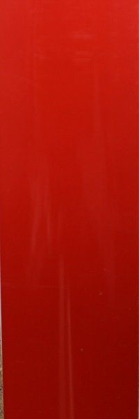 A close up of a red surface with a blurred background.