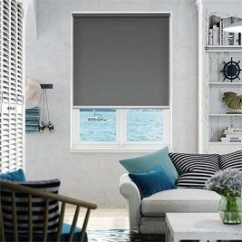 A living room with a couch , chair , table and window.