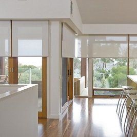 A kitchen with a lot of windows and stools