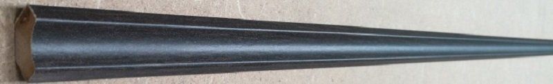 A black cone is sitting on top of a wooden table.