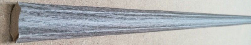 A metal cone is sitting on a wooden table.