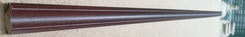 A metal cone is sitting on top of a wooden table.