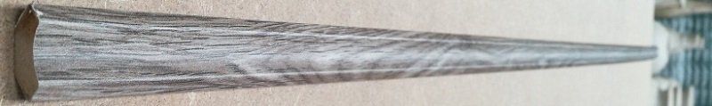 A cone shaped object is sitting on a wooden table.