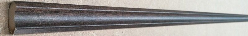 A metal cone is sitting on top of a wooden table.