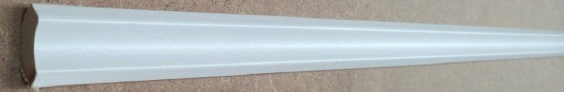 A white cone is sitting on a wooden table.