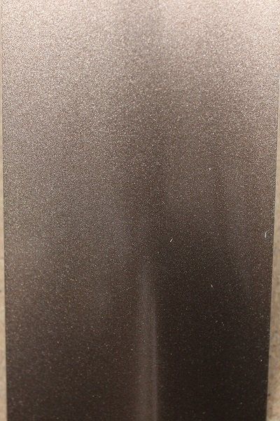 A close up of a metal surface with a grainy texture.