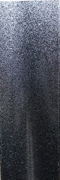 A close up of a black surface with a grainy texture.