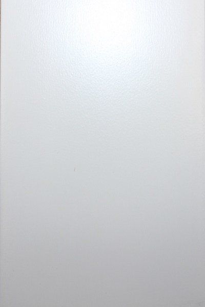 A close up of a white wall with a light shining through it.
