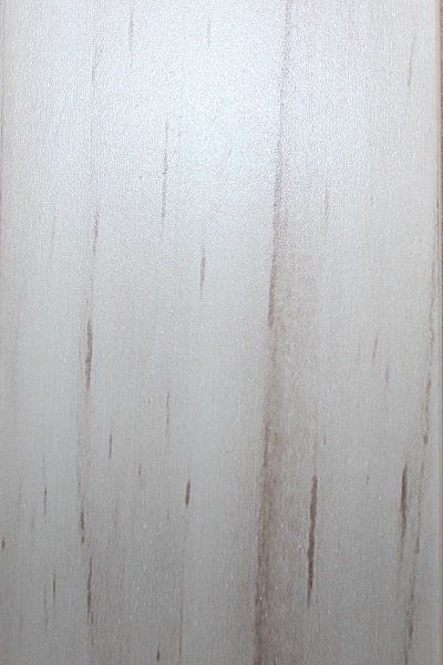 A close up of a white wall with a wood grain texture.