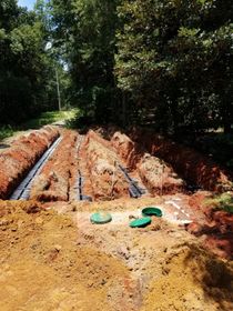man inspecting septic tank