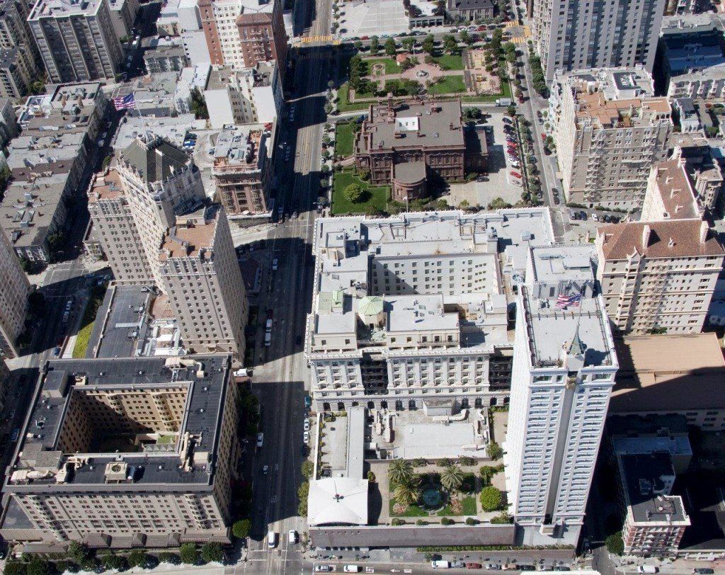 Aerial view of city buildings and a park with trees.