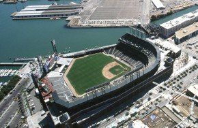 Aerial view of Oracle Park, a baseball stadium in San Francisco, next to water and docks.