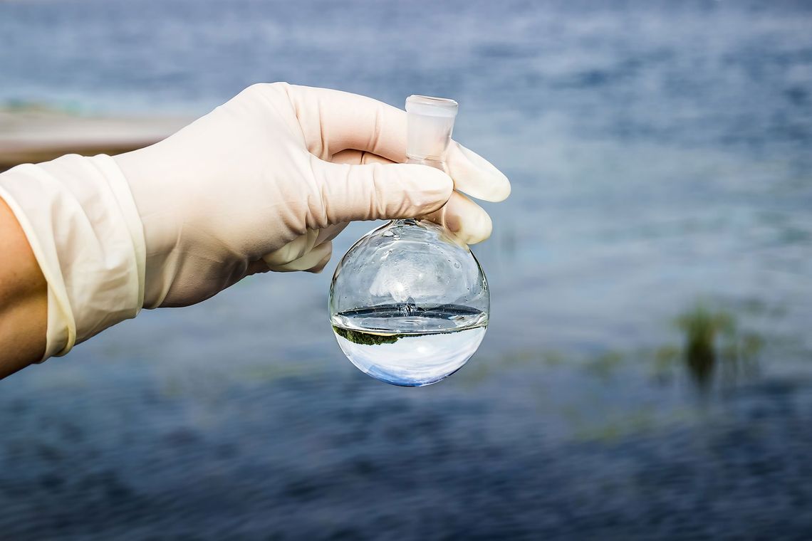 hand holding glass with water in it