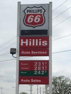 Phillips 66 gas station sign with fuel prices: Regular $2.31, Premium $2.81, Diesel $2.42. Hillis Auto Services and Sales.