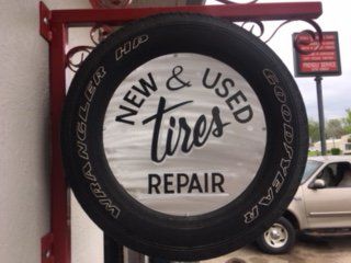 Tire shop sign: a tire-shaped sign with text