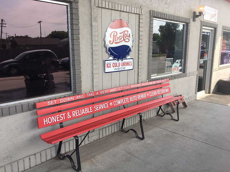 Red bench in front of a building with a Pepsi sign, labeled