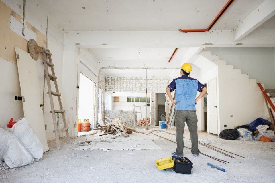 contractor looking at the renovation work