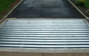 A metal grate on the side of a road.
