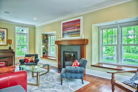 Well-Lit Living Room Featuring Glass Coffee Table